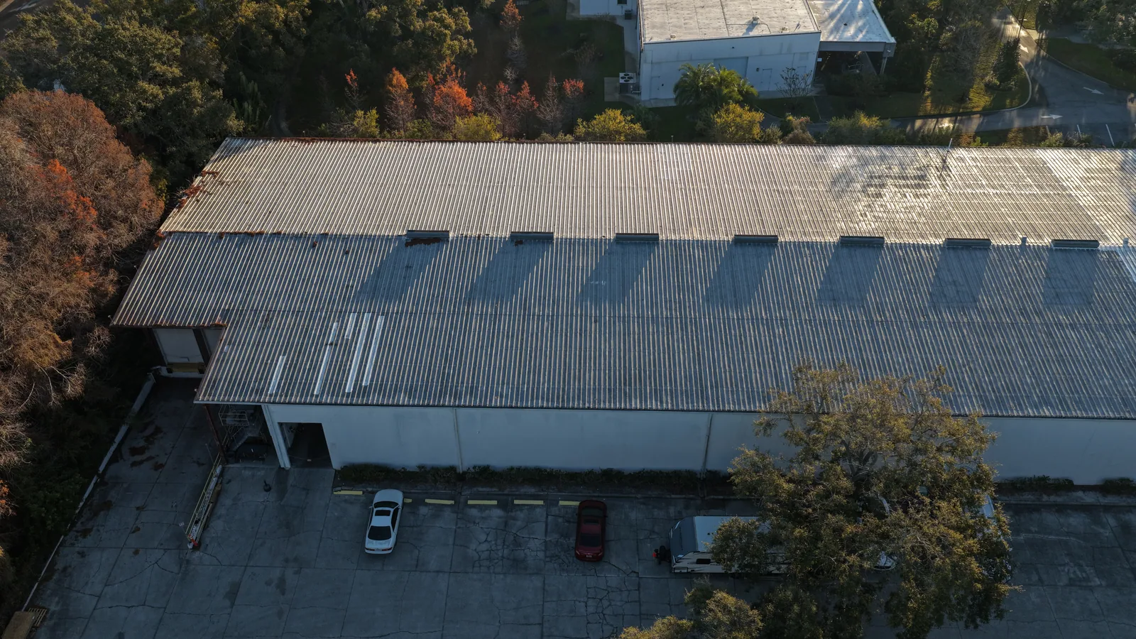 A whole-building roof record — An oblique view connects the metal roof, building and surrounding property.