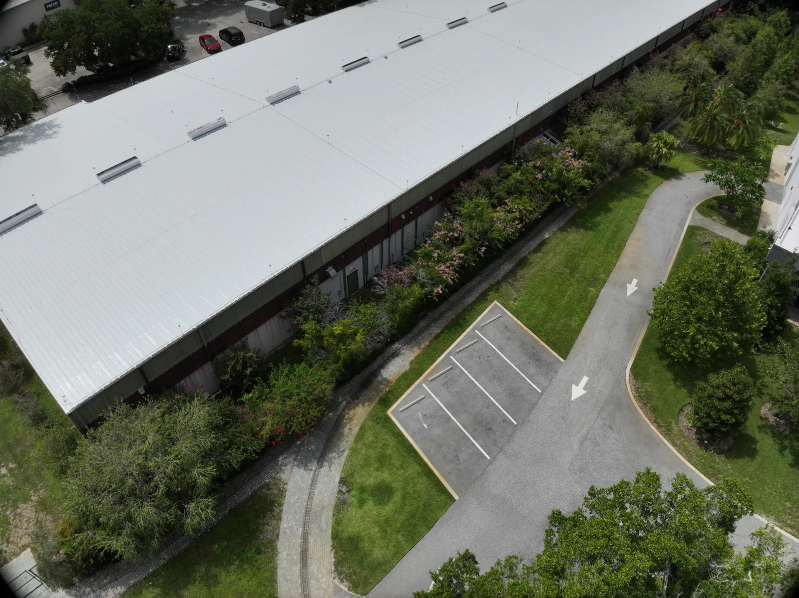 The wider project setting — A later property capture shows the building, roof and surrounding grounds.