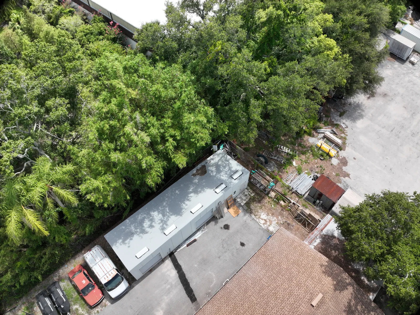 Work areas and access — An aerial context view shows part of the property, vehicles and work materials.
