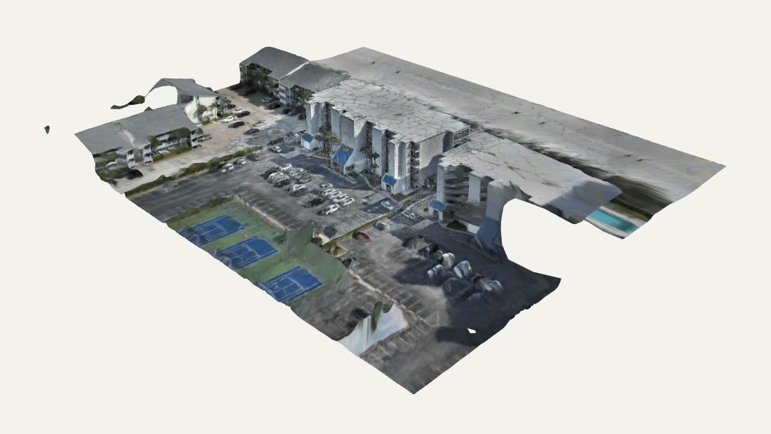 Actual Fly Maxwell textured 3D reconstruction showing connected roofs, facades, parking and recreation areas
